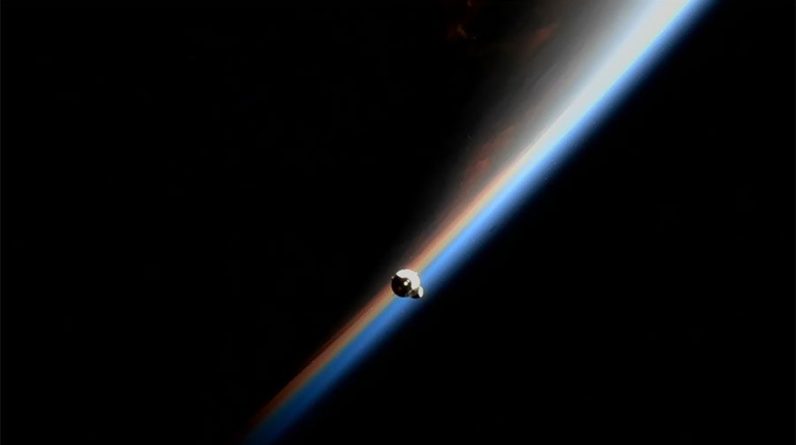 A SpaceX Dragon cargo capsule approaches the International Space Station during an orbital sunrise above the Pacific Ocean on July 16, 2022.